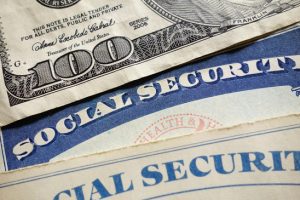 Closeup of US Social Security cards and money